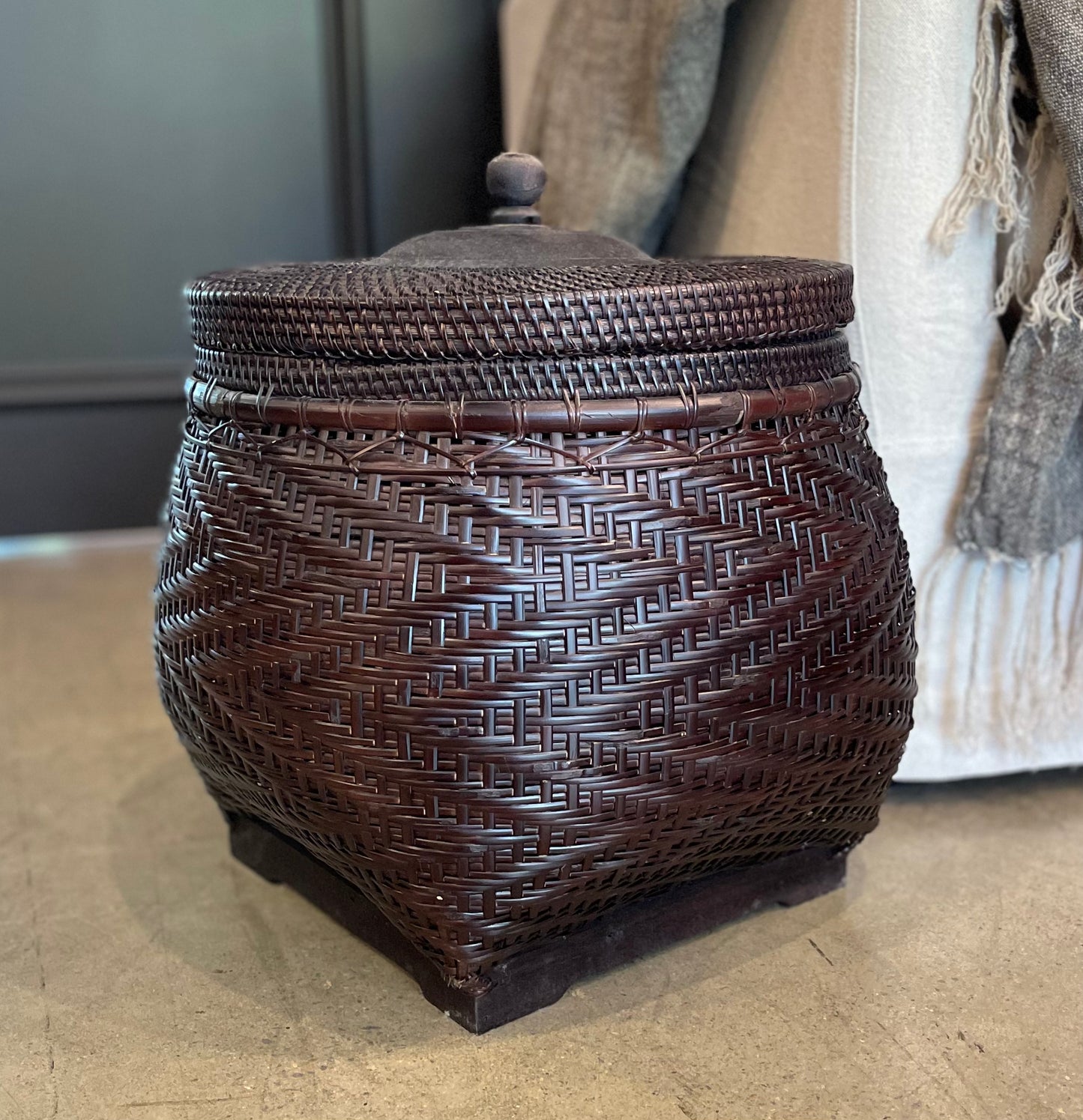 Crafted by skilled artisans from East Indonesian Island Villages using locally-sourced rattan and bamboo, the Cahyono Handmade Rattan & Bamboo Basket is visually stunning and exceptionally functional. Their deep, rich brown and black colour is complemented by a sturdy lid and wooden handle, making them the perfect choice for decorative accents or convenient storage solutions. Styled.