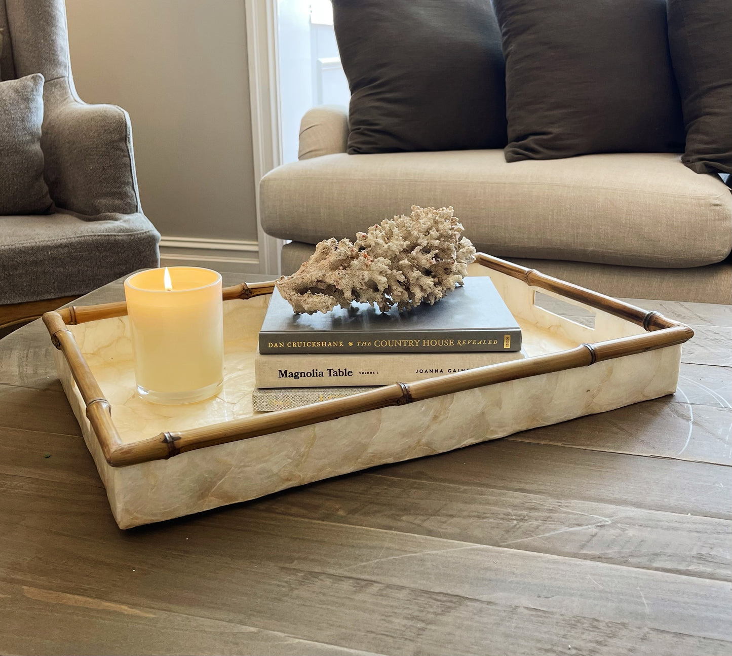 Crafted by skilled artisans in Southeast Asia, our Rectangle Capiz and Bamboo Tray adds a touch of elegance to any interior. Its sleek design and versatile size make it perfect for styling on consoles, coffee tables, or even in the bathroom. The soft tones of Capiz and the natural bamboo edge combine to create a unique and beautiful addition to any space. front