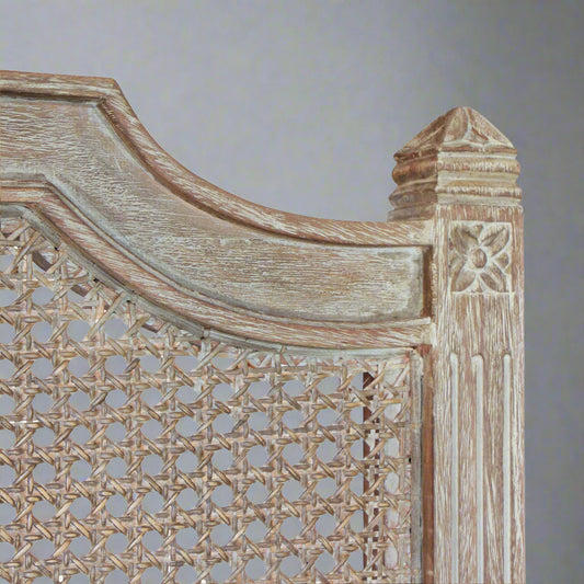 Transform your bedroom into a luxurious retreat with the stunning Sophia Bed Head. Crafted with exquisite rattan insert and elegant carved detailing on the posts, this piece adds a touch of timeless beauty to any room. Experience the allure of traditional charm and sophistication with Sophia Bed Head. Close up.