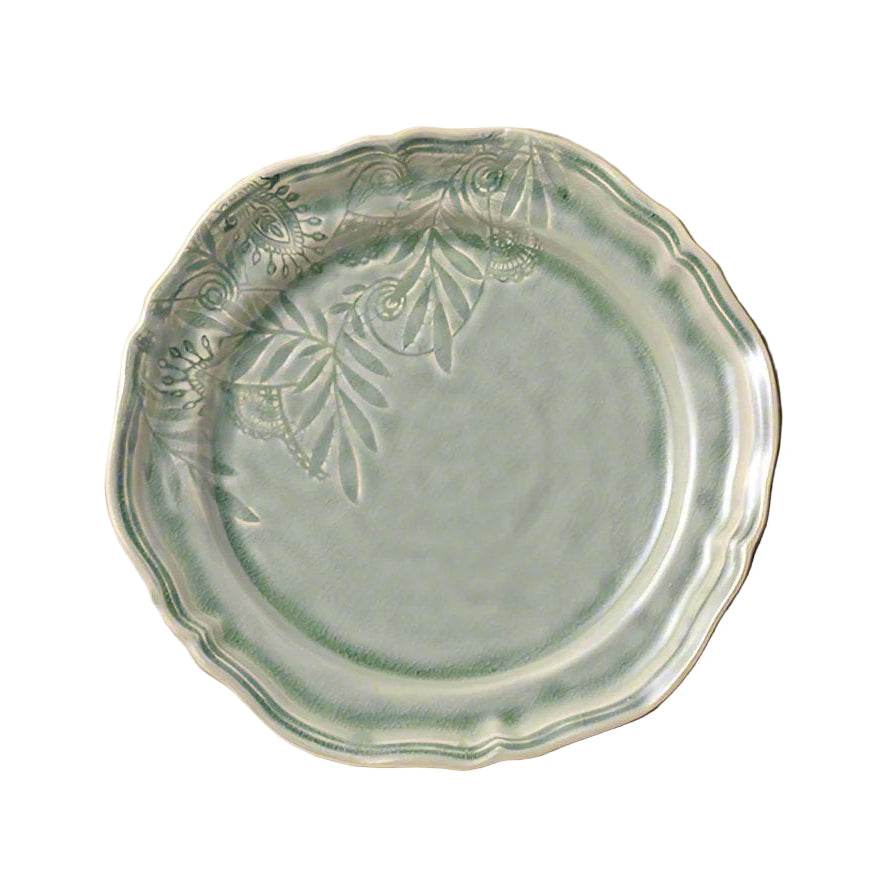 Green ceramic plate with leaf patterns on a white background