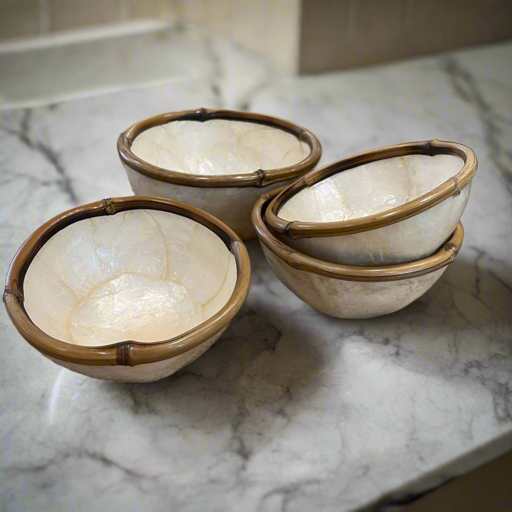 Experience the captivating beauty of our Capiz & Bamboo Bowl from Southeast Asia, featuring a charming design with a bamboo rim. Elevate any space with its versatile functionality as a decorative piece, trinket holder, or food serving dish. Styled.