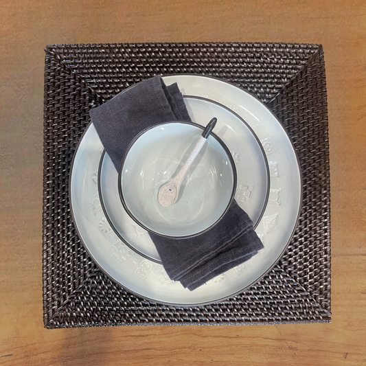 Our Handwoven Kotak Rattan Square Black Placemat offer an effective way to both decorate and protect your table. Styled.