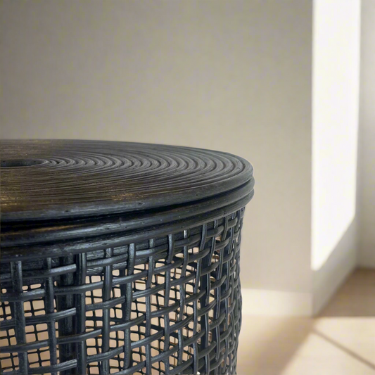 This Angkasa Handwoven Rattan Black Basket is expertly crafted in South East Asia, making it not only stylish but also incredibly practical for storage. Its basket shape, complete with a lid, adds to its functionality. With its sleek black hand-painted finish, it can seamlessly suit any room in your home. Close up.