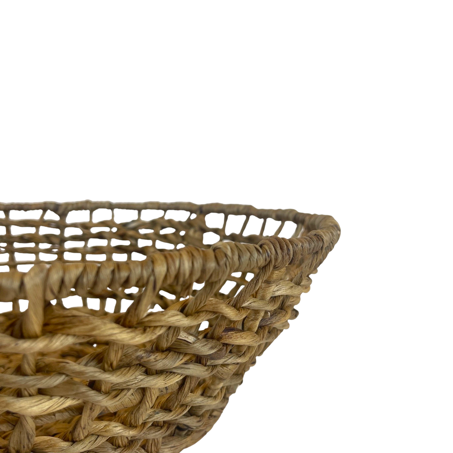 Inspired by the delicate structure of water hyacinth, the Bumi Water Hyacinth Bowl has a wide weave that is relaxed and organic, perfect for displaying your kitchen produce or styled alone. Close up.