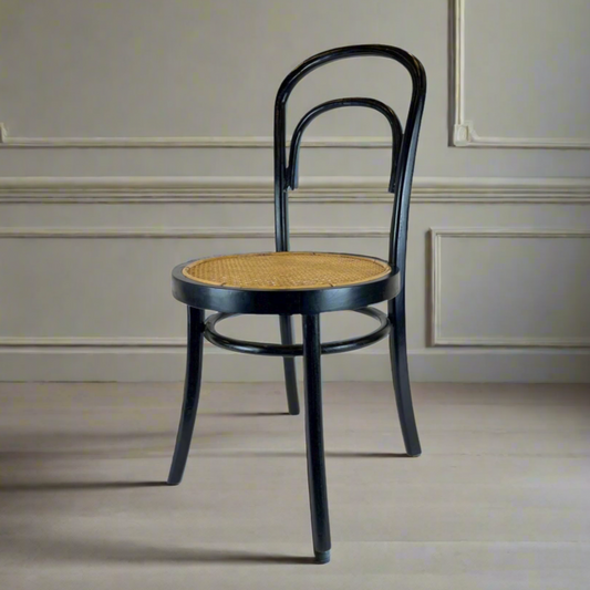 Designed with a black-finished teak frame, the Alam Rattan Chair has a simple arched back designed with and a natural woven seat. Front