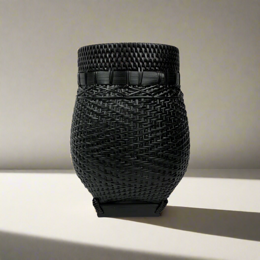 Handcrafted in traditional East Indonesian village communities, this stunning & unique Bakti Handmade Rattan & Bamboo Basket combines the natural beauty of rattan & bamboo to add texture and charm to your living space. The deep brown and black tones of the bamboo base make it perfect for storage, displaying plants, or simply as an eye-catching accent piece.