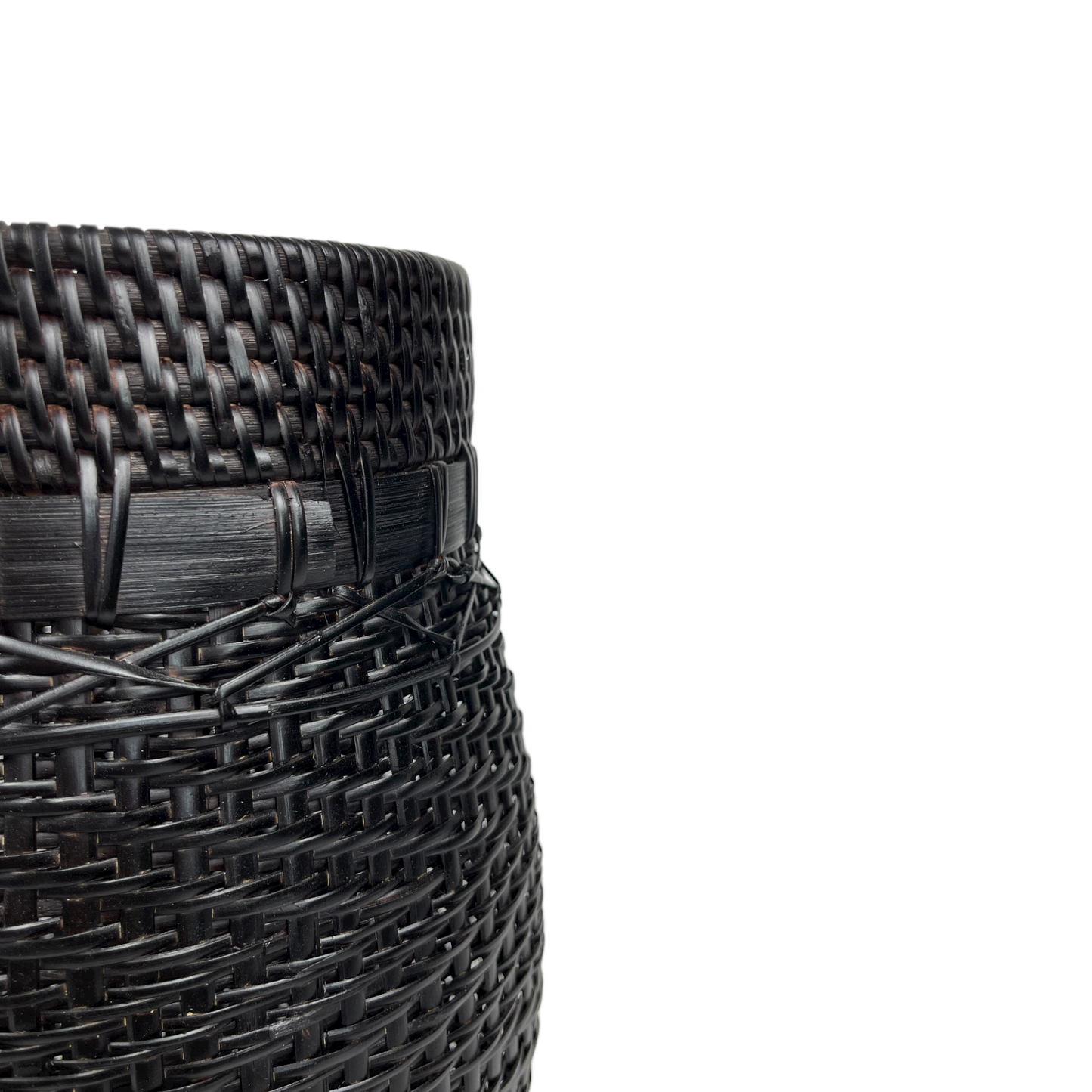 Handcrafted in traditional East Indonesian village communities, this stunning & unique Bakti Handmade Rattan & Bamboo Basket combines the natural beauty of rattan & bamboo to add texture and charm to your living space. The deep brown and black tones of the bamboo base make it perfect for storage, displaying plants, or simply as an eye-catching accent piece. Close up.