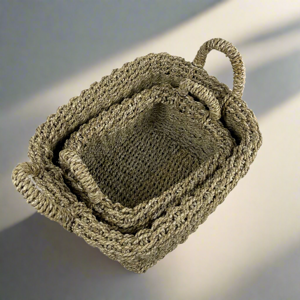 Tightly handwoven from seagrass, our Saudari Seagrass Baskets feature sturdy handles which add charm and understated style. Use to display indoor plants or for a wide range of storage options. Stacked styled.