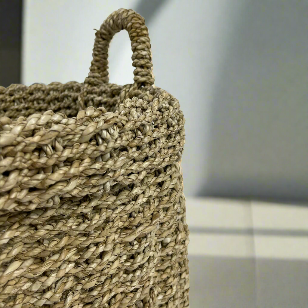 Tightly handwoven from seagrass, our Saudari Seagrass Baskets feature sturdy handles which add charm and understated style. Use to display indoor plants or for a wide range of storage options. Close up.