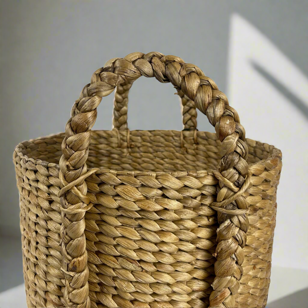 The Keranjang Water Hyacinth Basket is crafted from sustainable Water Hyacinth, bringing both practicality and beauty to your household. Whether for pantry storage or laundry, this basket has got you covered. Close up.