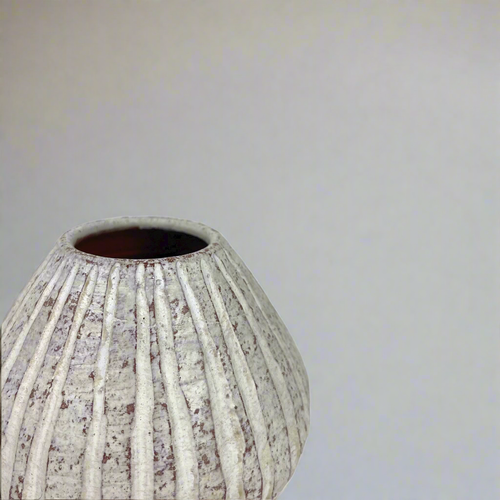 This beautiful rustic terracotta vase with neutral white tones makes it perfect for the bedroom, to place on a bedside table or as part of the living room decor. Corner
