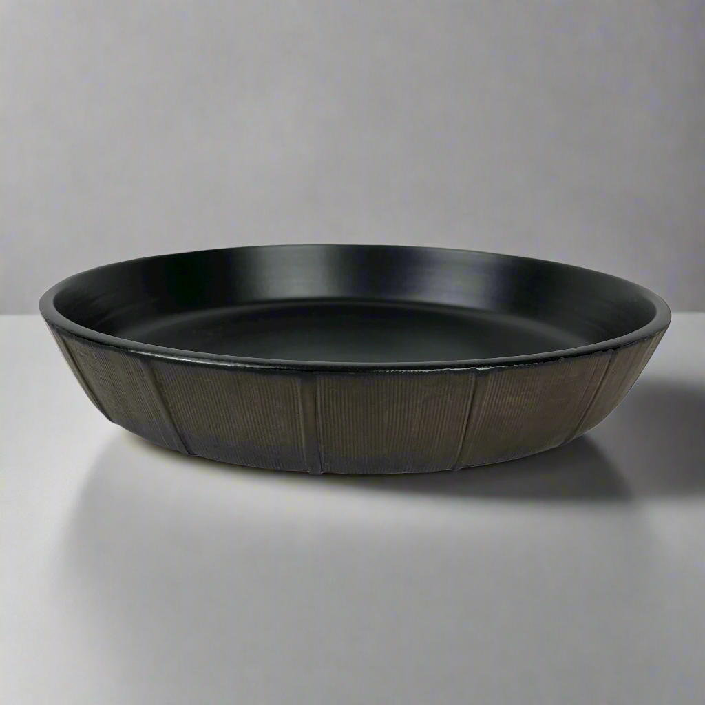 The Positano Bronze Serving Bowl boasts elegant rich tones & a versatile shape perfect for adorning your everyday table with timeless style.