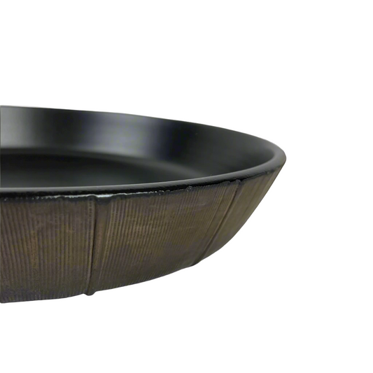 The Positano Bronze Serving Bowl boasts elegant rich tones & a versatile shape perfect for adorning your everyday table with timeless style. Detail.