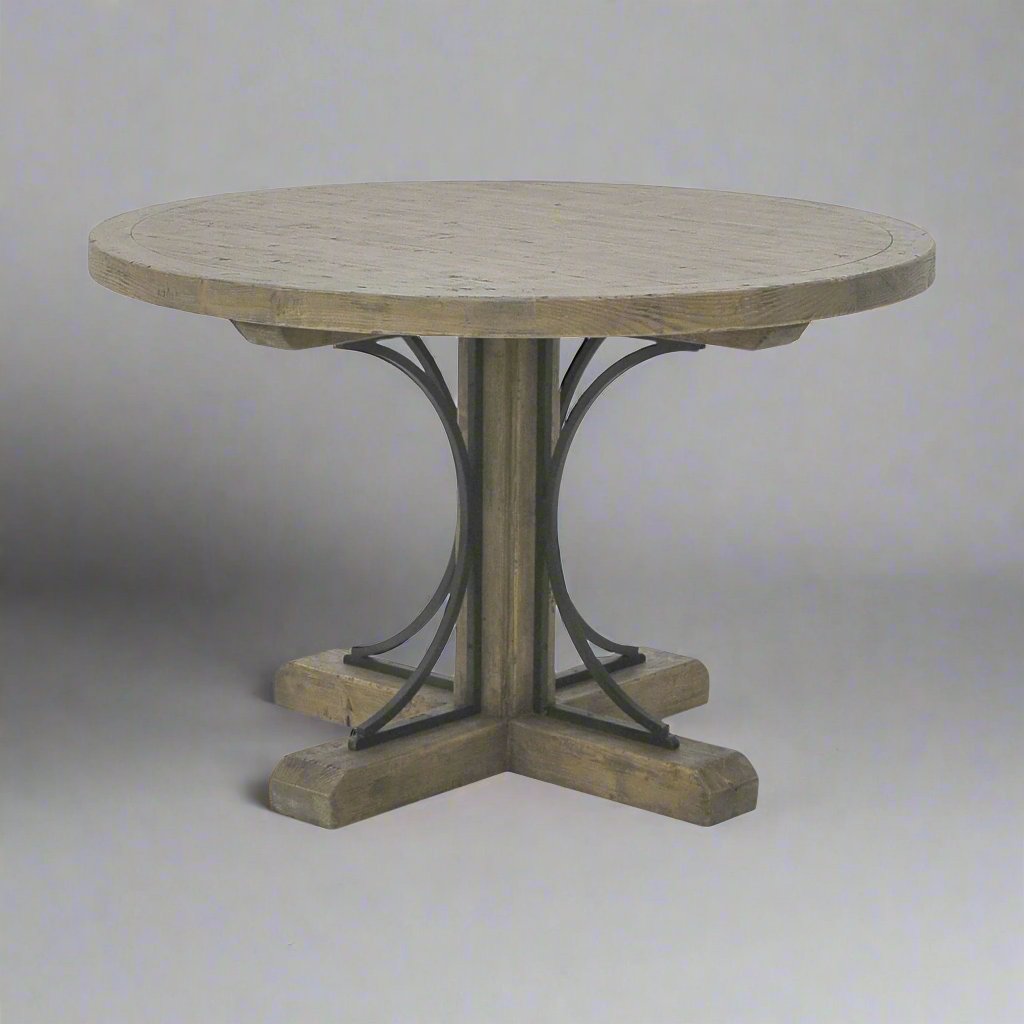 The Avignon Round Dining Table is crafted from fruitwood and features subtle architectural iron detail. Front