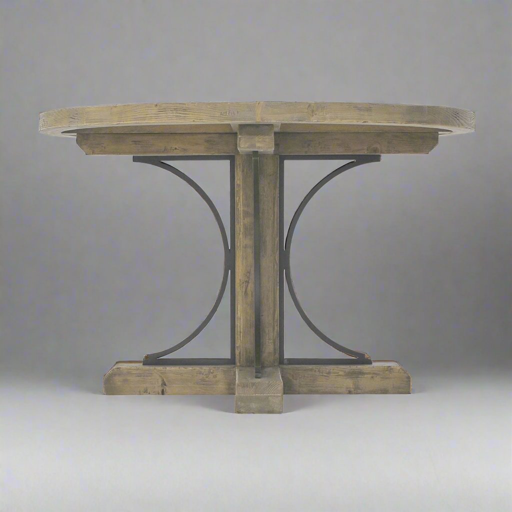 The Avignon Round Dining Table is crafted from fruitwood and features subtle architectural iron detail. Front