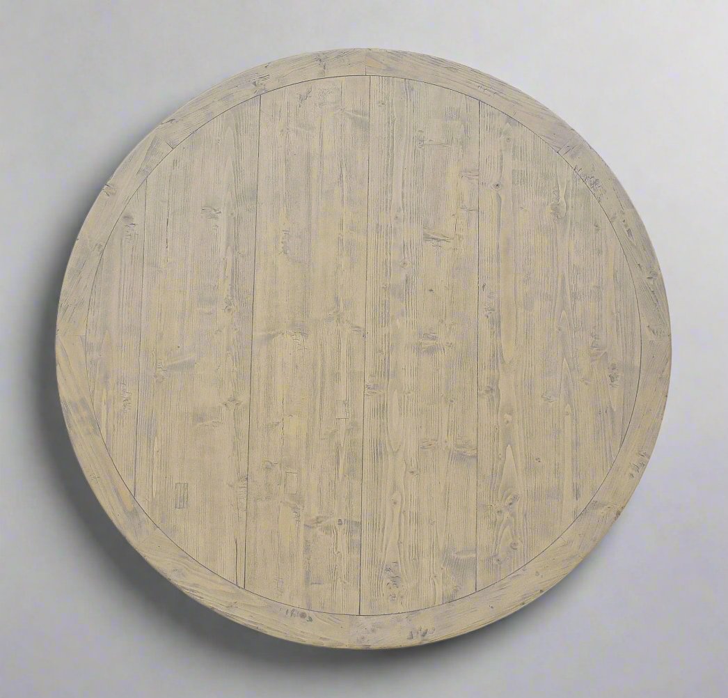 The Avignon Round Dining Table is crafted from fruitwood and features subtle architectural iron detail. Top