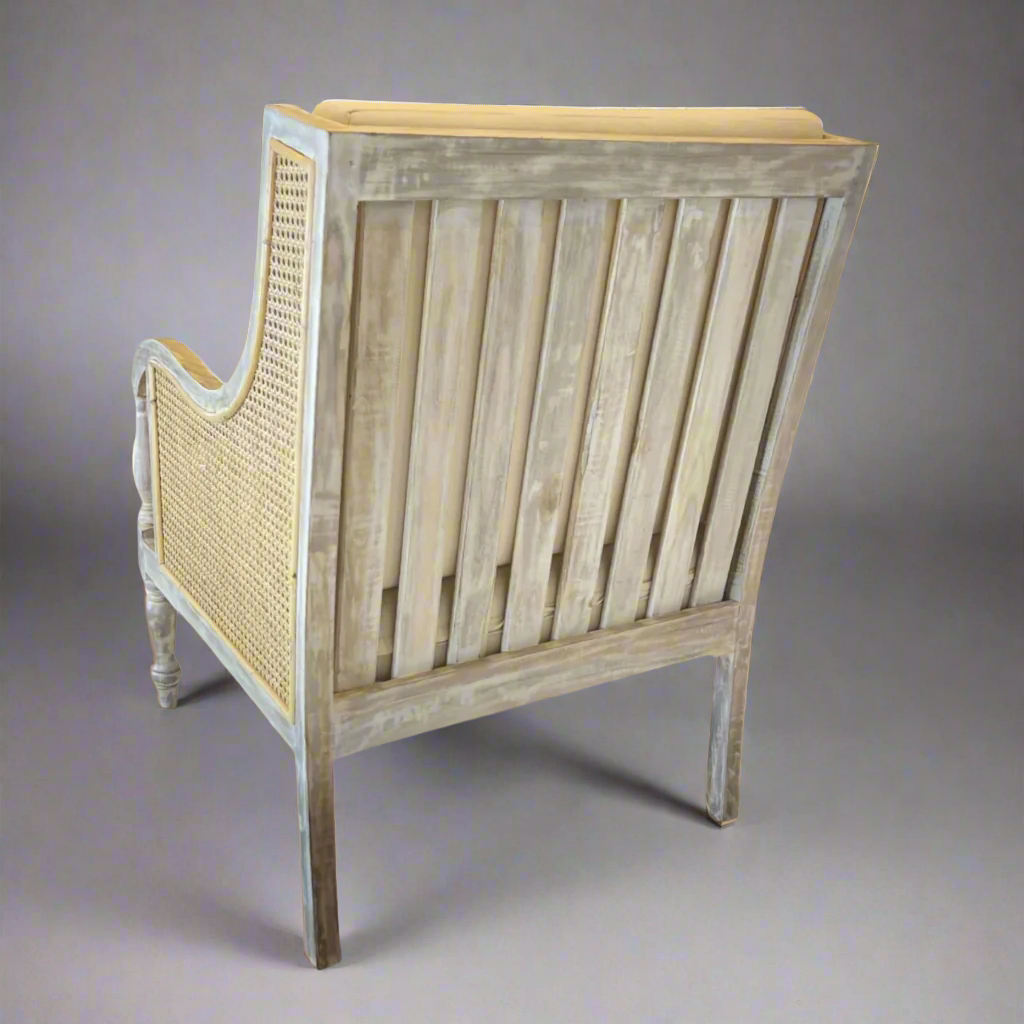 Crafted from teak and rattan, this very attractive and desireable elegant armchair with period features boasts a delicate distressed finish that lends it the patina of age. Back
