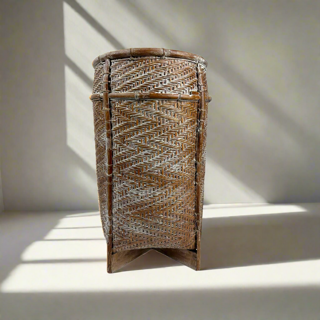 Crafted in a number of East Indonesian Island Villages, this striking Amisha Handwoven Bamboo & Rattan Basket can be used as an accent piece or to provide additional useful storage.