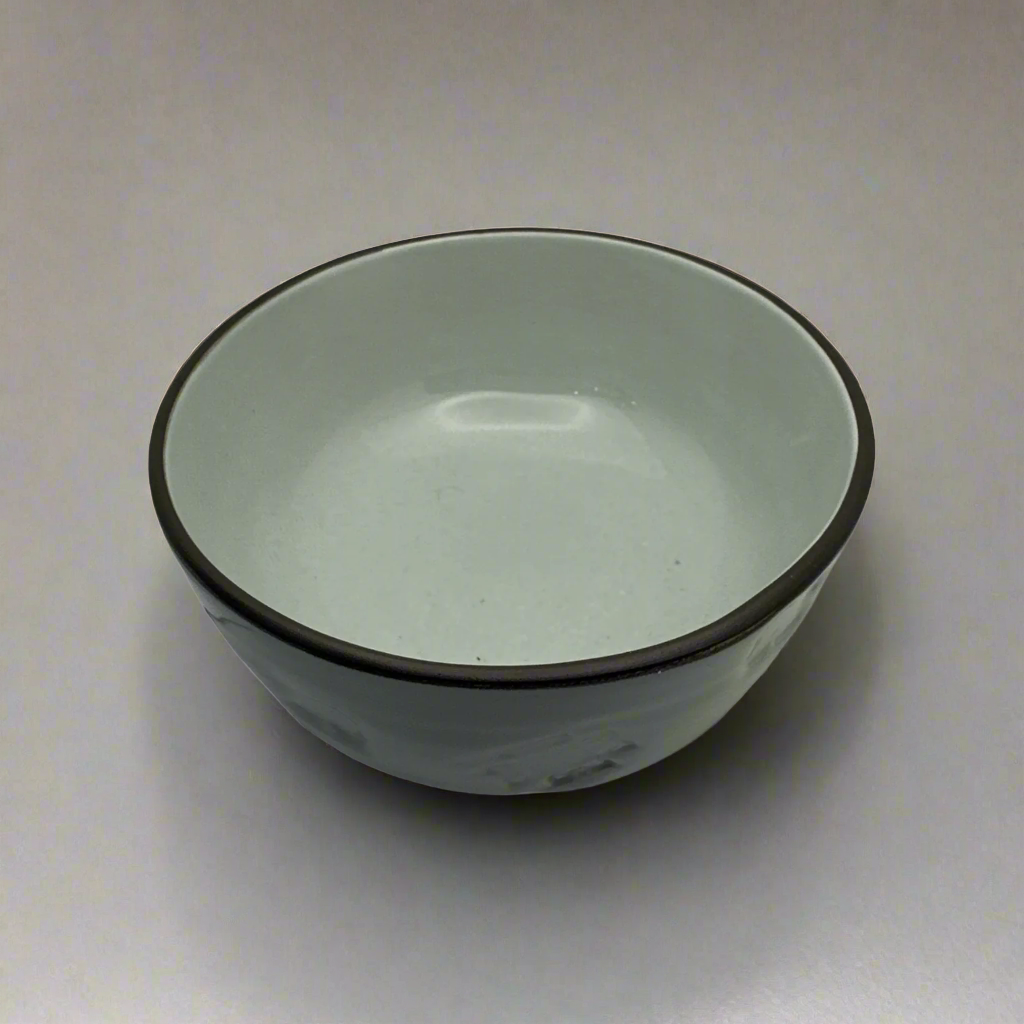 Add a subtle elegance to your dinner table with the Domah Side Bowl. Its lightly-coloured design is accented with distinctive grey edges and features the unique symbolism of Indonesian archipelagos. Crafted exclusively by HOME by MB, this bowl offers a timeless look that instantly upgrades any home décor. Top.