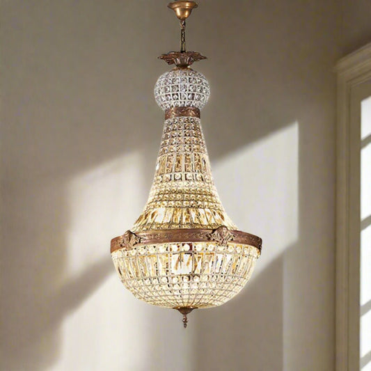 An elegant Versailles chandelier with glass pieces and a metallic structure, hanging from the ceiling.