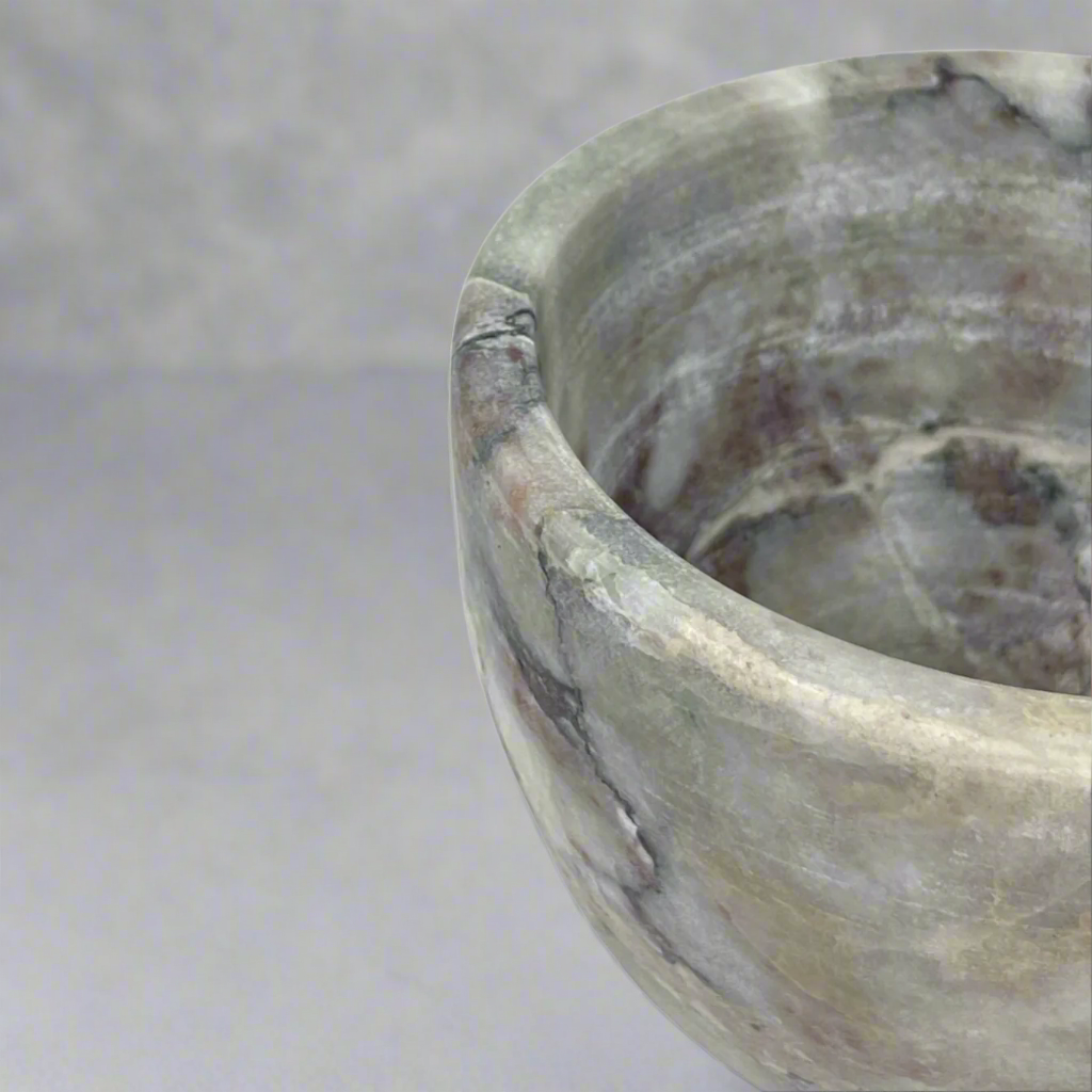 The natural veining of off-white, brown and grey tones of our Sangiran Stone Bowl blend perfectly with its understated artisan shape.