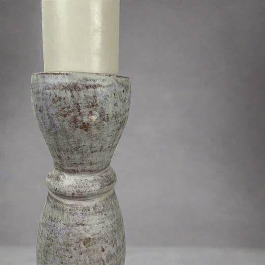 Crafted from terracotta, this chunky yet elegant Poppi Terracotta Candle Holder is substantial enough to work on its own or as a beautiful collection of candle holders on a mantelpiece or a table. Close up.