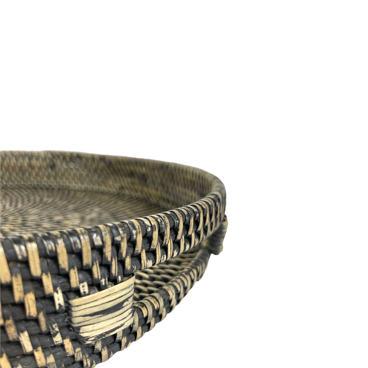Enrich your space with the Pecatu Rattan Tray, a beautifully handwoven piece that adds texture and style to any coffee table or ottoman. Its functional handles allow for easy transport when entertaining. Corner close-up