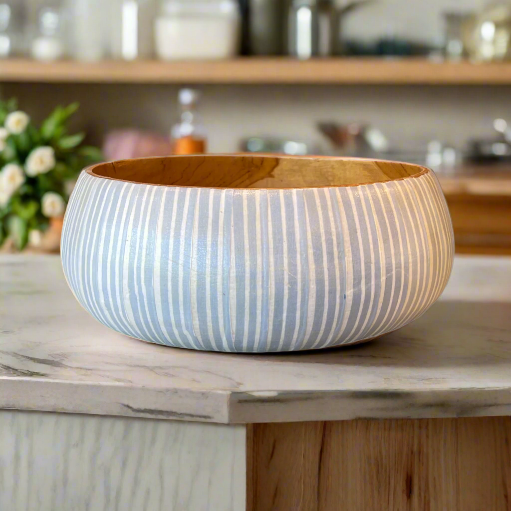 Artfully crafted, our Blue & White Batik Bowls lend just the right amount of texture and dimension to your table. Formed from teak wood, the warm reddish-brown hues and beautiful natural grains perfectly pair with the playful handcrafted Batik pattern.