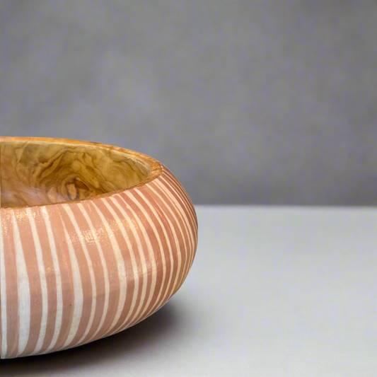 Artfully designed, our Handcrafted Batik & Teak Wood Bowl lend just the right amount of texture and dimension to your table. Formed from teak wood, the warm reddish-brown hues and beautiful natural grains perfectly pair with the playful Batik pattern. Detail.