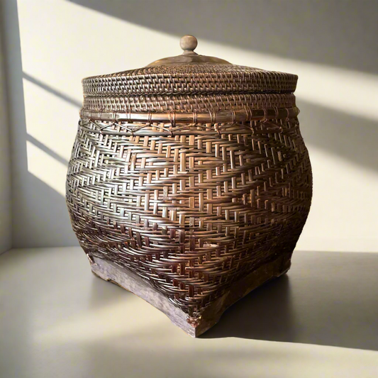 Crafted by skilled artisans from East Indonesian Island Villages using locally-sourced rattan and bamboo, the Cahyono Handmade Rattan & Bamboo Basket is visually stunning and exceptionally functional. Their deep, rich brown and black colour is complemented by a sturdy lid and wooden handle, making them the perfect choice for decorative accents or convenient storage solutions.