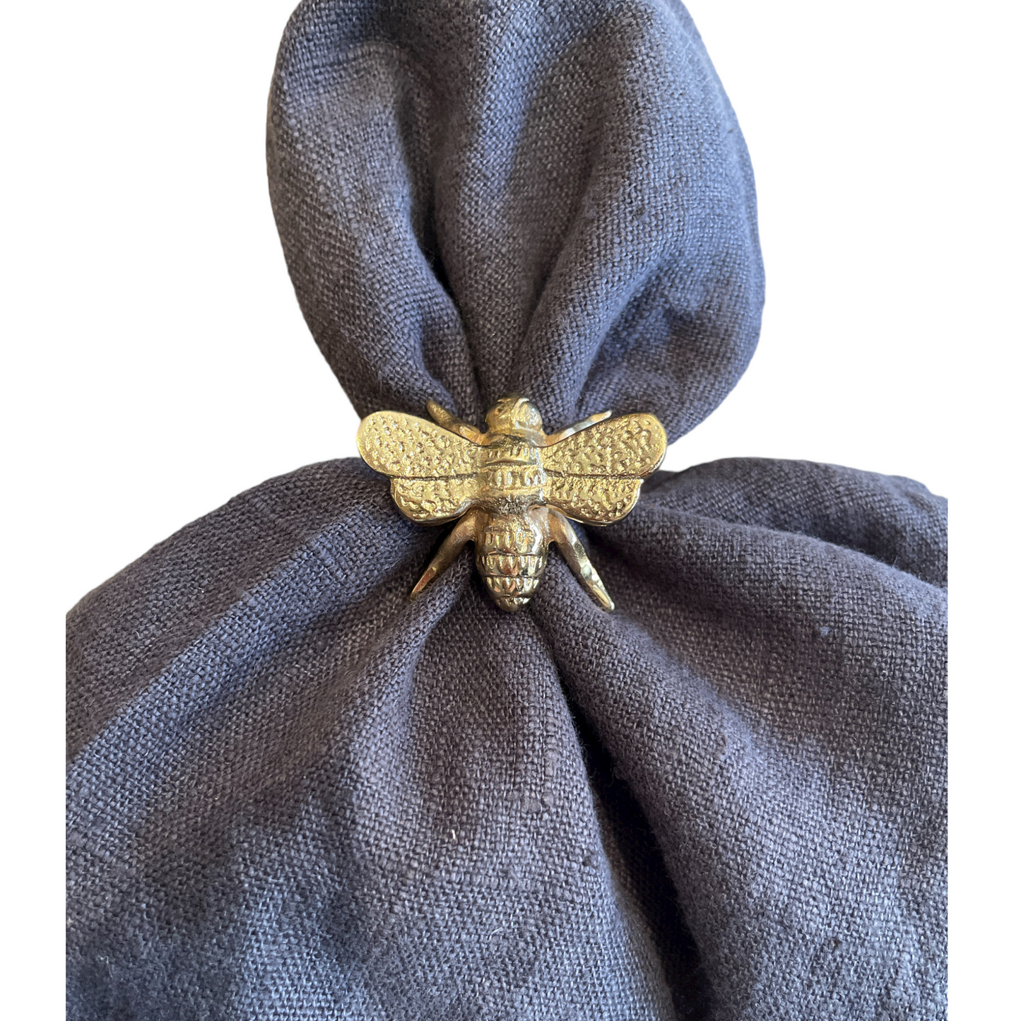 Add a touch of nature to your dining experience with the Brass Bee Napkin Ring. Made of solid brass, this delightful ring adds a touch of elegance to your table setting. Front