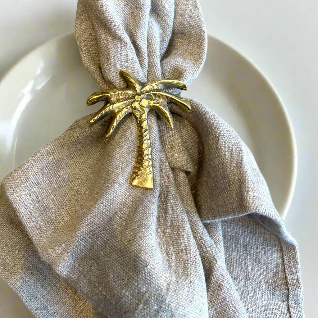 Our solid brass napkin ring. Featuring a fun Coconut Tree design. The perfect addition to the elegance of your dining table. Front