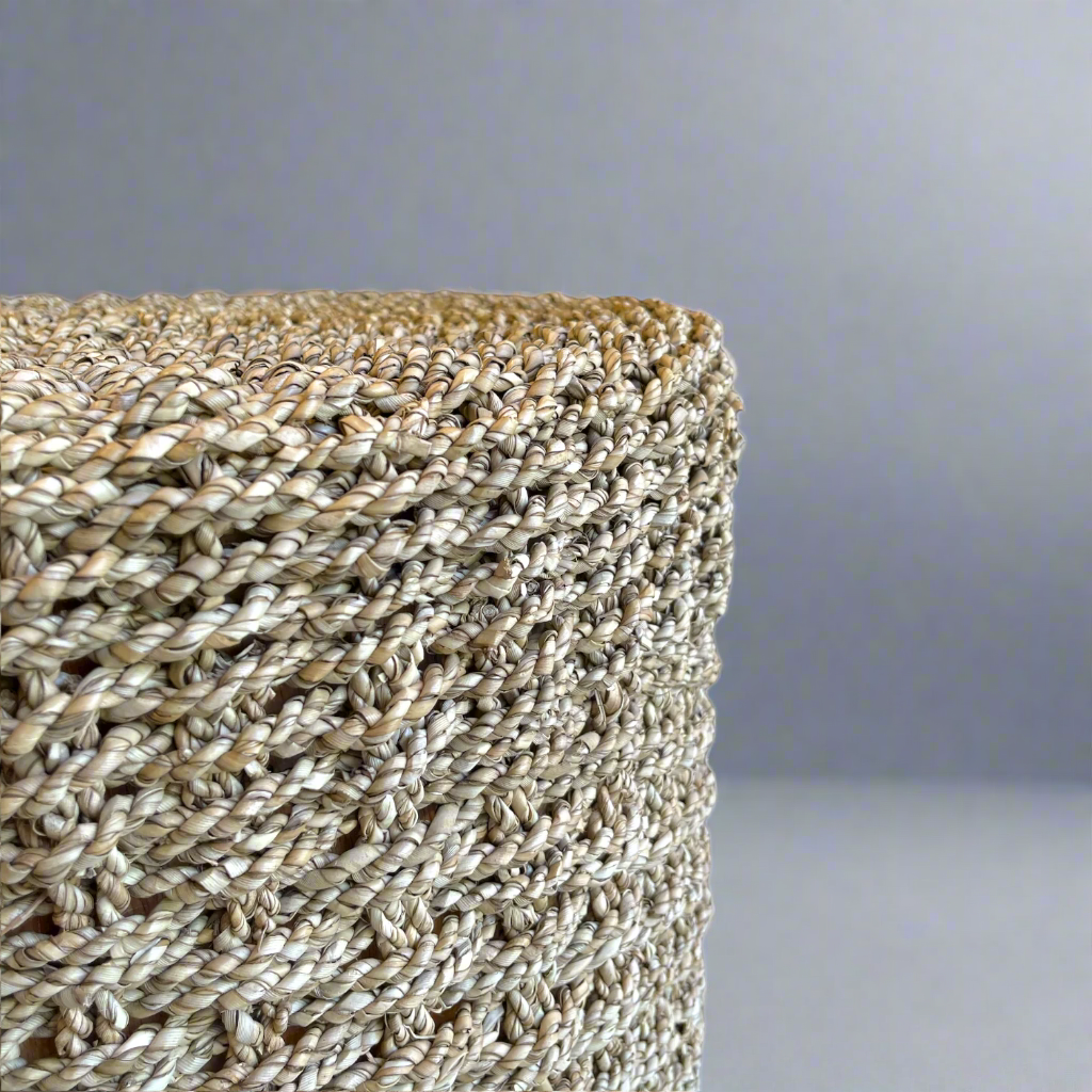 The Kursi Seagrass Side Table is a beautiful addition to seating areas or bedrooms. Woven from seagrass, the tight weave gives a dimensional quality to this table, adding a sense of movement and individuality. Corner