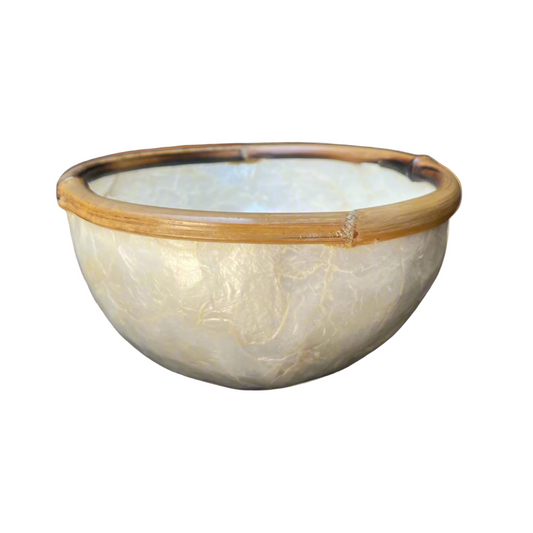 Experience the captivating beauty of our Capiz & Bamboo Bowl from Southeast Asia, featuring a charming design with a bamboo rim. Elevate any space with its versatile functionality as a decorative piece, trinket holder, or food serving dish. Side