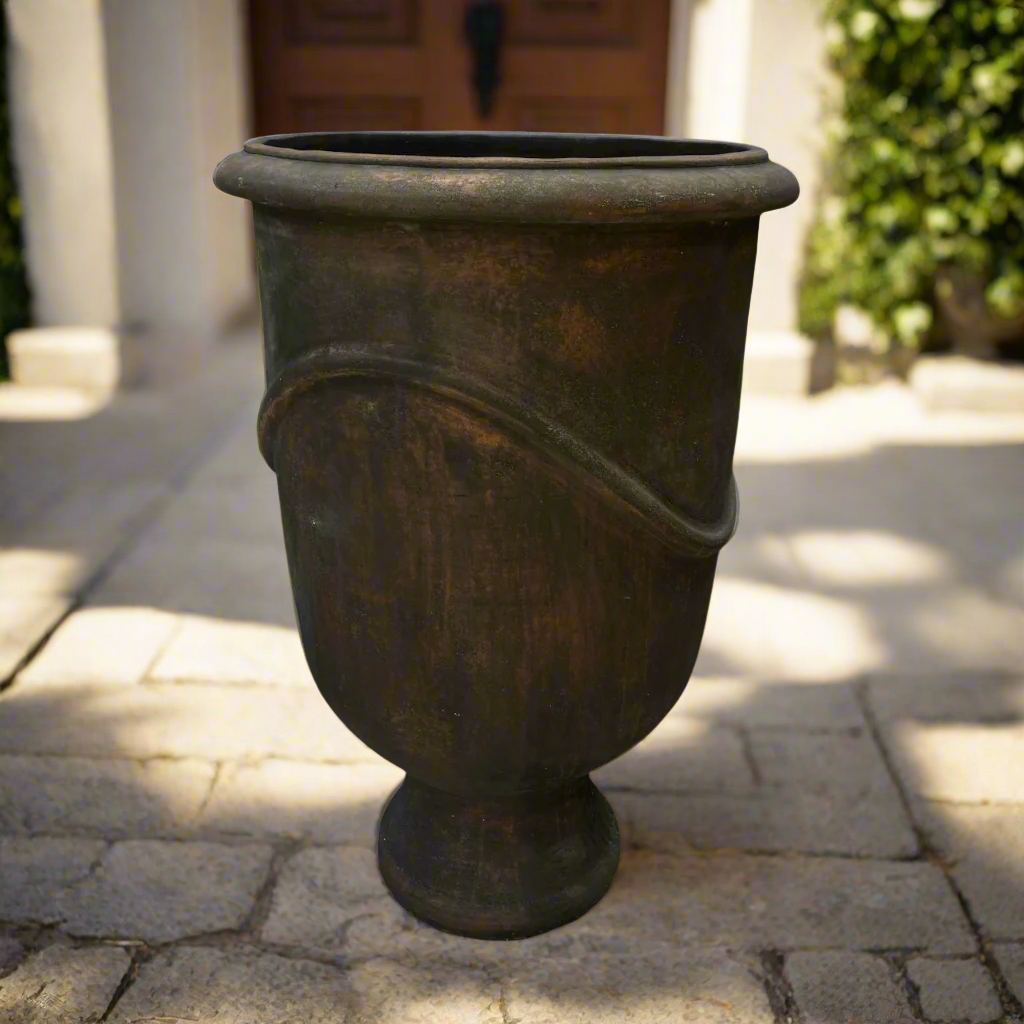 Indulge in the timeless design and rustic charm of this textured pot. Its classic shape and pared-back aesthetic give it a unique character that will enhance any space.