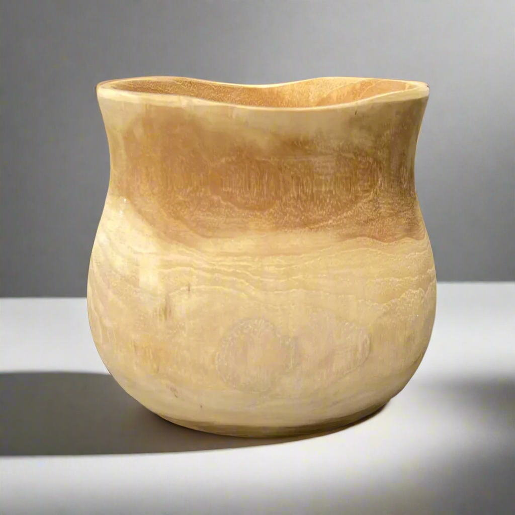 Lovingly crafted from solid teak, our Handcarved Gunung Teak Bowl features the best of both organic and airy design. With a light hue and plenty of natural knots and grains, each bowl is unique.