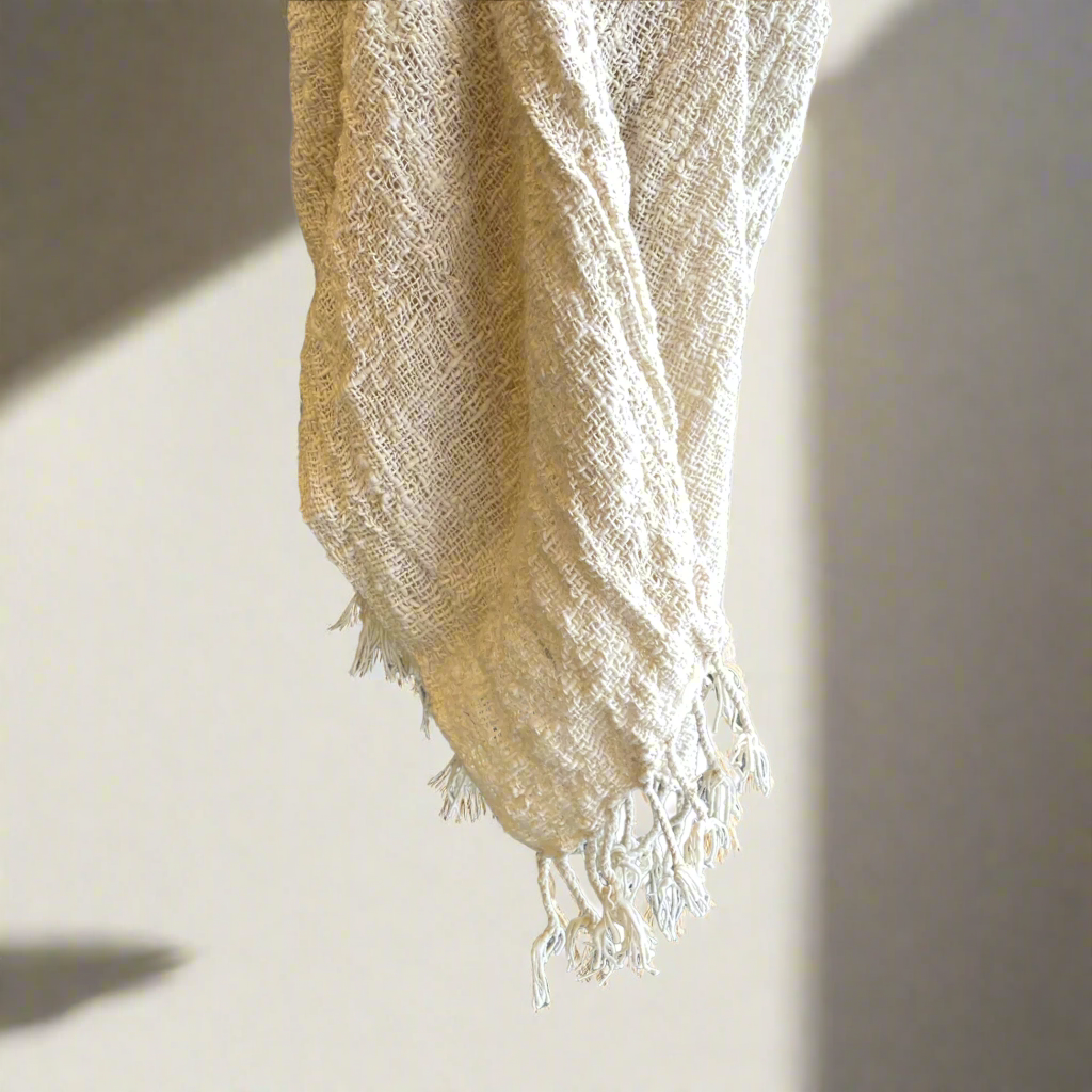 Enhance your living spaces with luxurious, tactile throws that exude a sense of warmth and comfort. These handwoven throws are crafted from raw cotton, boasting a rustic texture and adorned with tassels for added elegance.