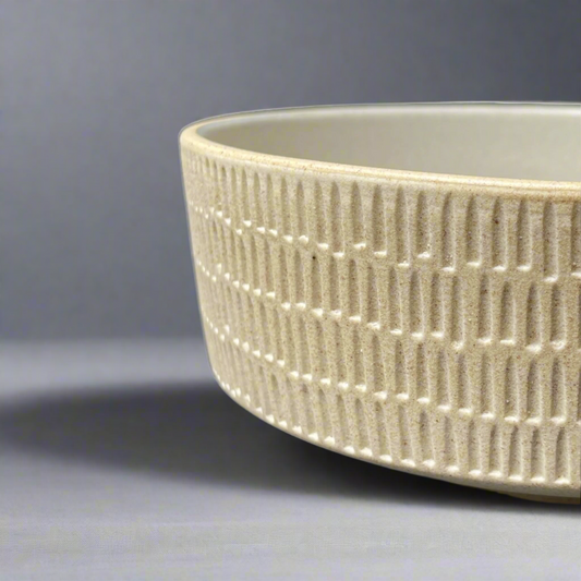 The Tembi Bowl boasts a simple yet contemporary shape and is perfect for adorning your everyday table scape with timeless style. Side.