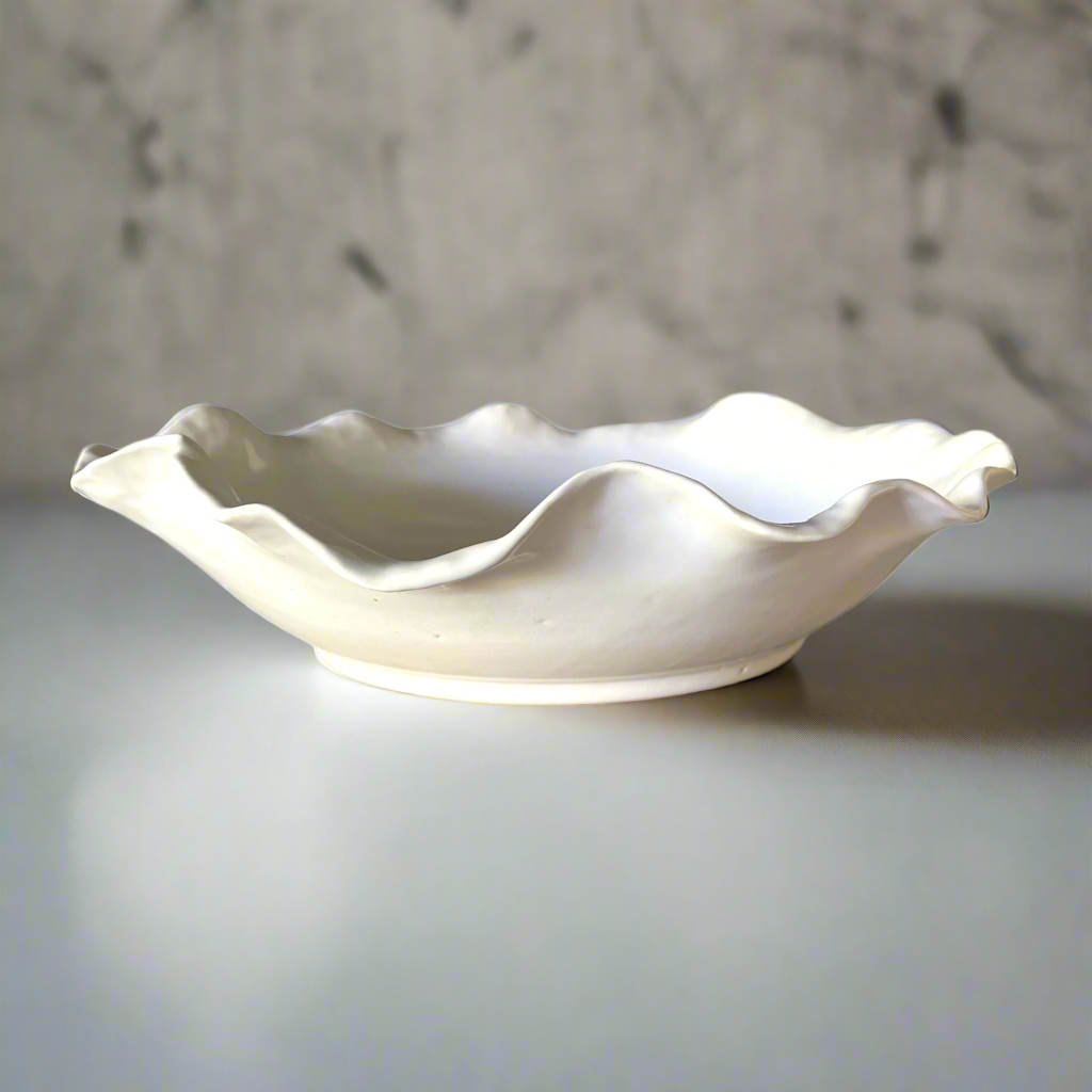 Our Cream Handmade Lida Glazed Bowl is a beautiful handmade piece, with tactile qualities that are evident in its organic shape and distinctive glazed finish. The subtle cream stoneware brings a stylish aesthetic to your tabletop.