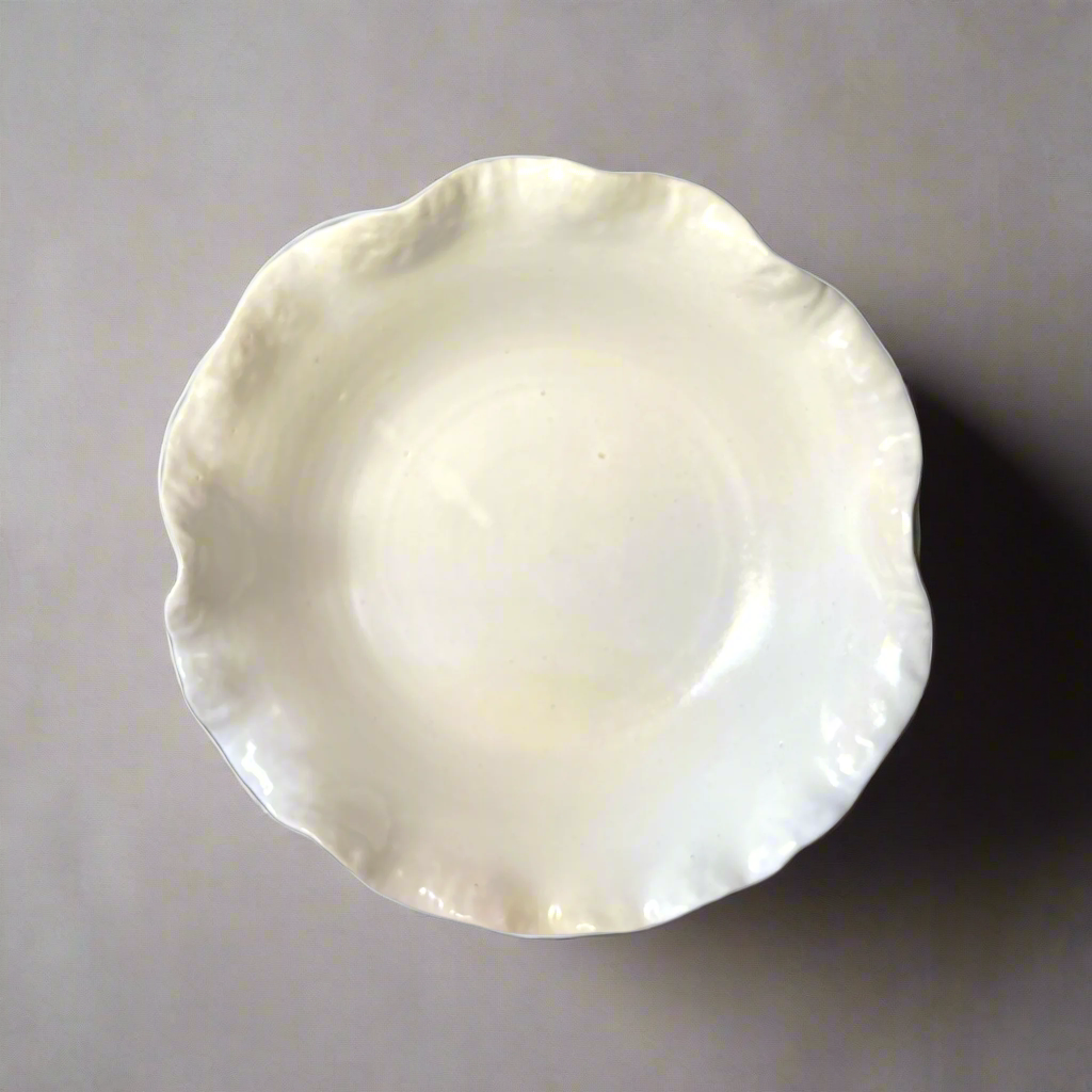 Our Cream Handmade Lida Glazed Bowl is a beautiful handmade piece, with tactile qualities that are evident in its organic shape and distinctive glazed finish. The subtle cream stoneware brings a stylish aesthetic to your tabletop. Top.