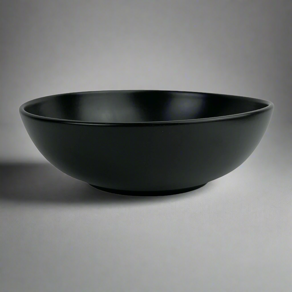 Experience the simplistic elegance of our Handcrafted Black Jenis Bowl, designed with a smooth and gentle edge for a touch of refinement.