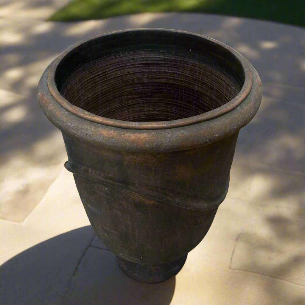 Indulge in the timeless design and rustic charm of this textured pot. Its classic shape and pared-back aesthetic give it a unique character that will enhance any space.