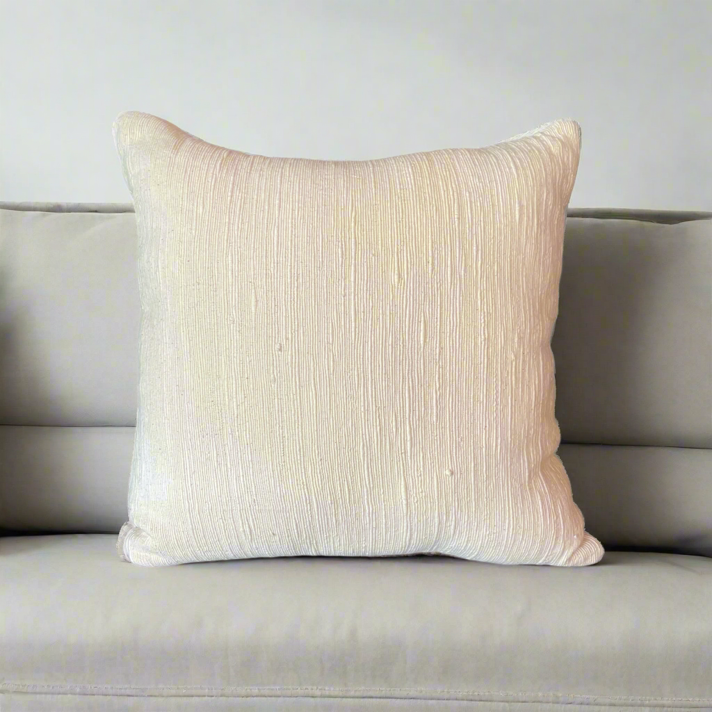 Experience the luxurious beauty of the Kediri Handwoven Cotton Cream Cushion, a sophisticated and versatile addition to your decor. Its elegant neutral tones and indulgently comfortable insert create a truly exceptional piece.