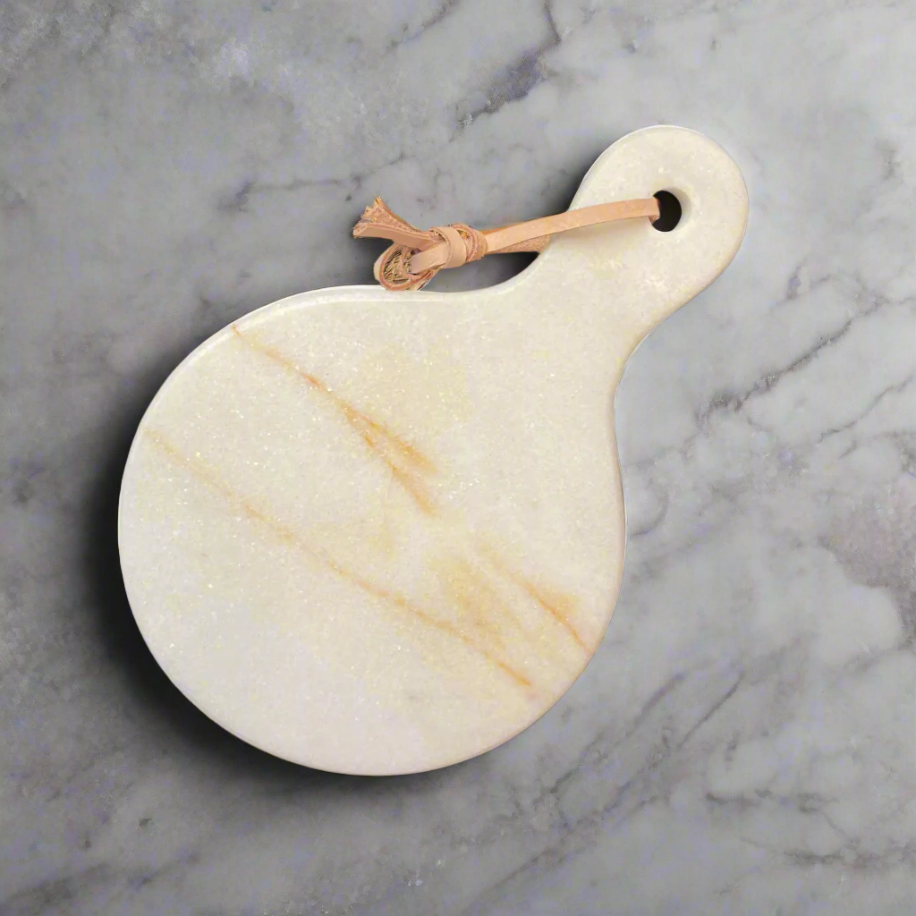 Experience the beauty of natural marble with the Puti Marble Cheese Board. The exquisite warm tones of the marble are elegantly marbled throughout, creating a sophisticated and artistic look. Its curved edges add a touch of elegance to your plating and presentation, making it a must-have for any entertaining occasion.