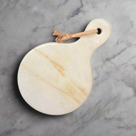 Experience the beauty of natural marble with the Puti Marble Cheese Board. The exquisite warm tones of the marble are elegantly marbled throughout, creating a sophisticated and artistic look. Its curved edges add a touch of elegance to your plating and presentation, making it a must-have for any entertaining occasion.