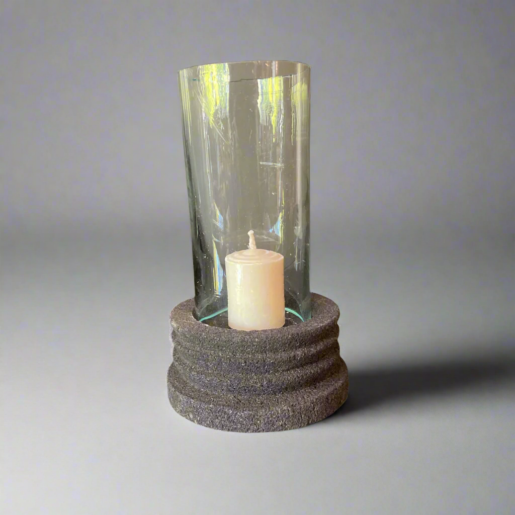 Experience the beauty of the Handmade Lava Stone Candle Holder with a glass cylinder. It will elevate any table and captivate as an ornamental piece using a single tealight.