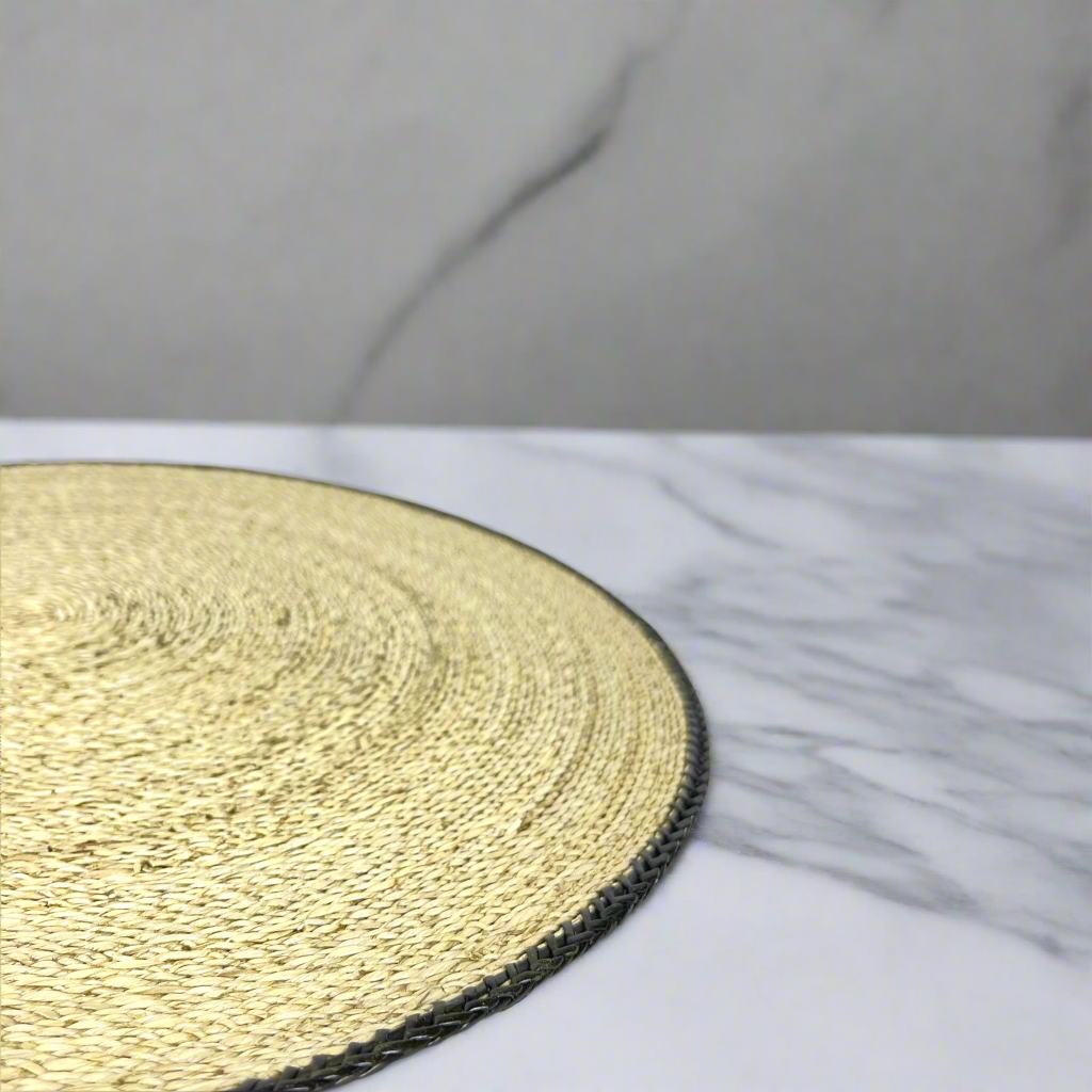 Our Handwoven Pandan Natural Round Placemat With Black Trim offers a great way to both decorate and protect your table. Corner close up.