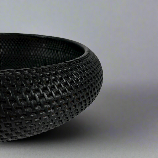Get ready to elevate your home decor with our Bergaya Black Rattan Bowl. Carefully crafted with an artful touch, this stylish piece will add a beautiful texture to any room, instantly capturing attention and admiration. Detail.