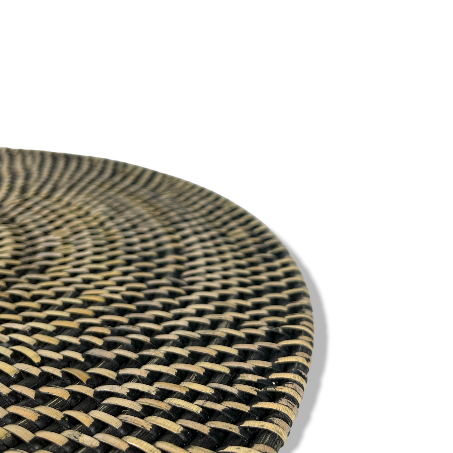Transform your table into a work of art with our exquisite Handwoven Putih Rattan Black and Natural Round Placemat. Close up detail.