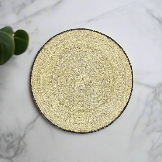 Our Handwoven Pandan Natural Round Placemat With Black Trim offers a great way to both decorate and protect your table.